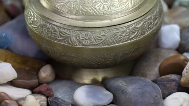 Sea Stones And Oyster Shells Around Gold Old Bowl Rotating — Stock Video