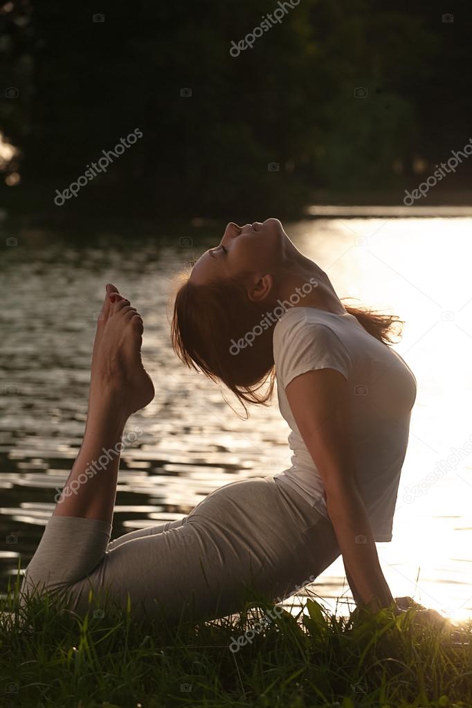 Yoga style girl on sunset or sunrise, healthy lifestyle concept.