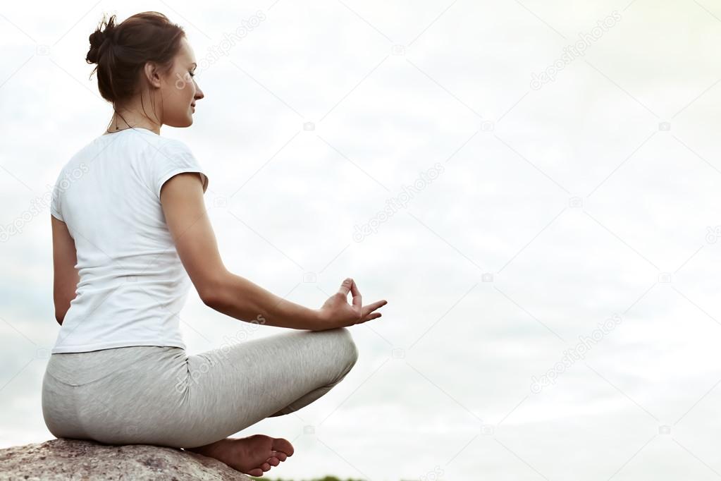 Yoga girl making a dzen or zen and smilling.