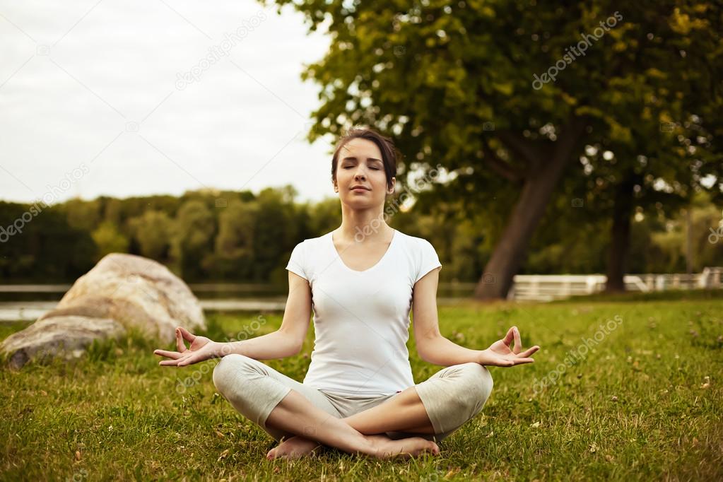Relaxing and meditation - Yoga woman meditating at bank river on sunset.