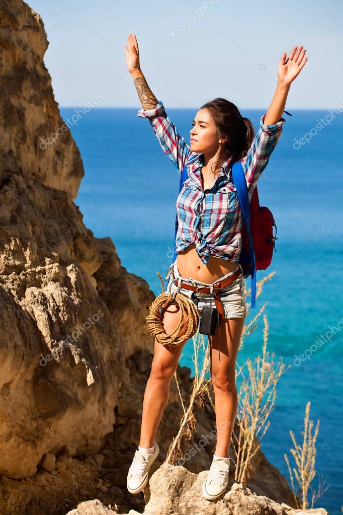Young woman traveler hiking girl with backpack hiking in mountains