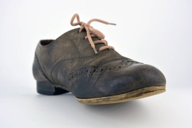 Beyaz arka planda dişi deri ayakkabılar var. Düz topuklu gri ayakkabı bağcıkları olan Oxford ayakkabıları. Gri kadın ayakkabıları, farkında olmadan bağlanıyor..