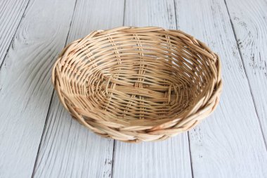 Empty weaved basket on the wooden table.