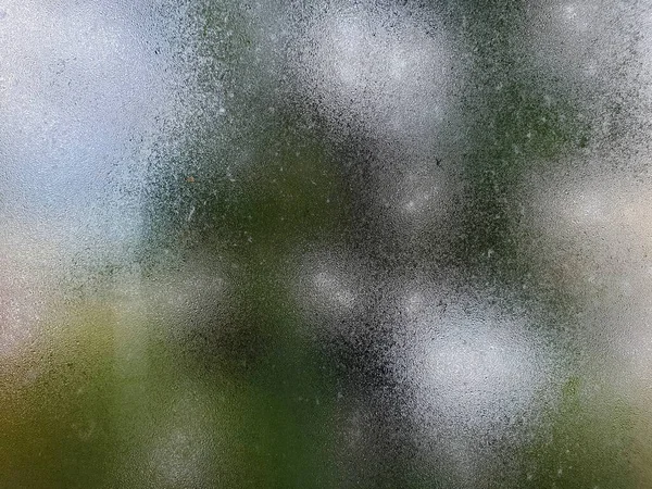 Water drops steam of rain on window glass after the rain