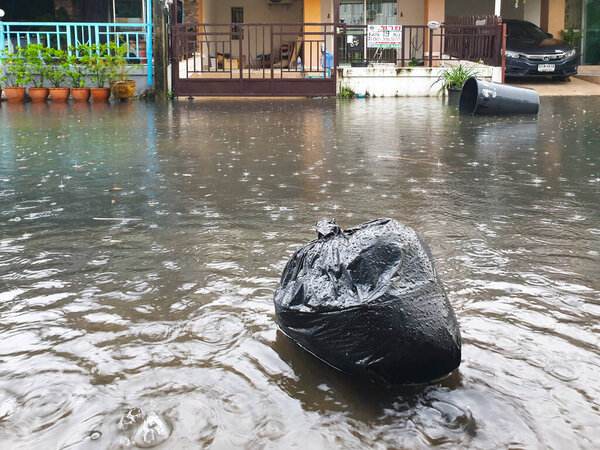 Bangkok, Thailand - August 5, 2021 : Water flood in Bangkok city problem with the manhole overflow in drainage system it full from garbage when rain storm.
