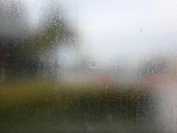 Water drops steam of rain on window glass after the rain