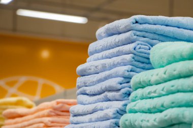 Mağazada yumuşak banyo havlusu satışı. Spa aksesuarları yığını.