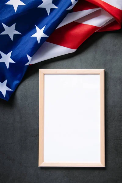 Empty frame for text and American flag on a dark background. Concept of celebrating national holidays - Independence Day, Memorial Day or Labor Day.