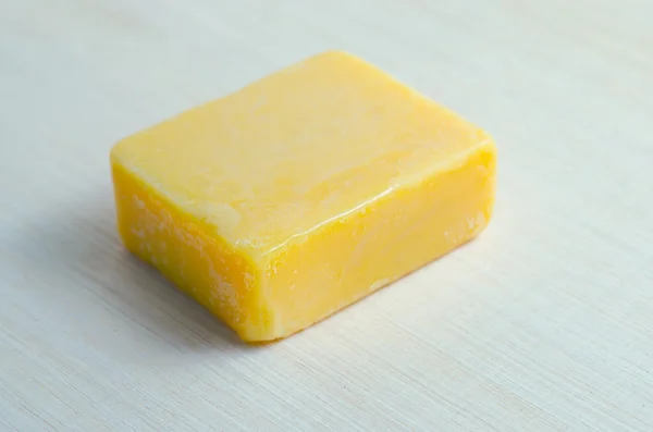 Soap bar flavor with mango ingredient isolated on wooden board b — Stock Photo, Image