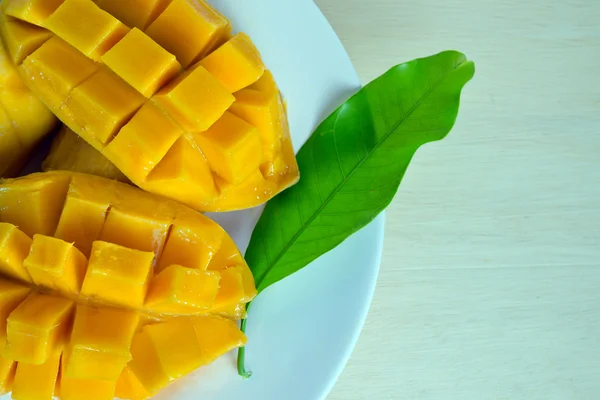 In Scheiben geschnittene reife gelbe Mango mit Blatt — Stockfoto