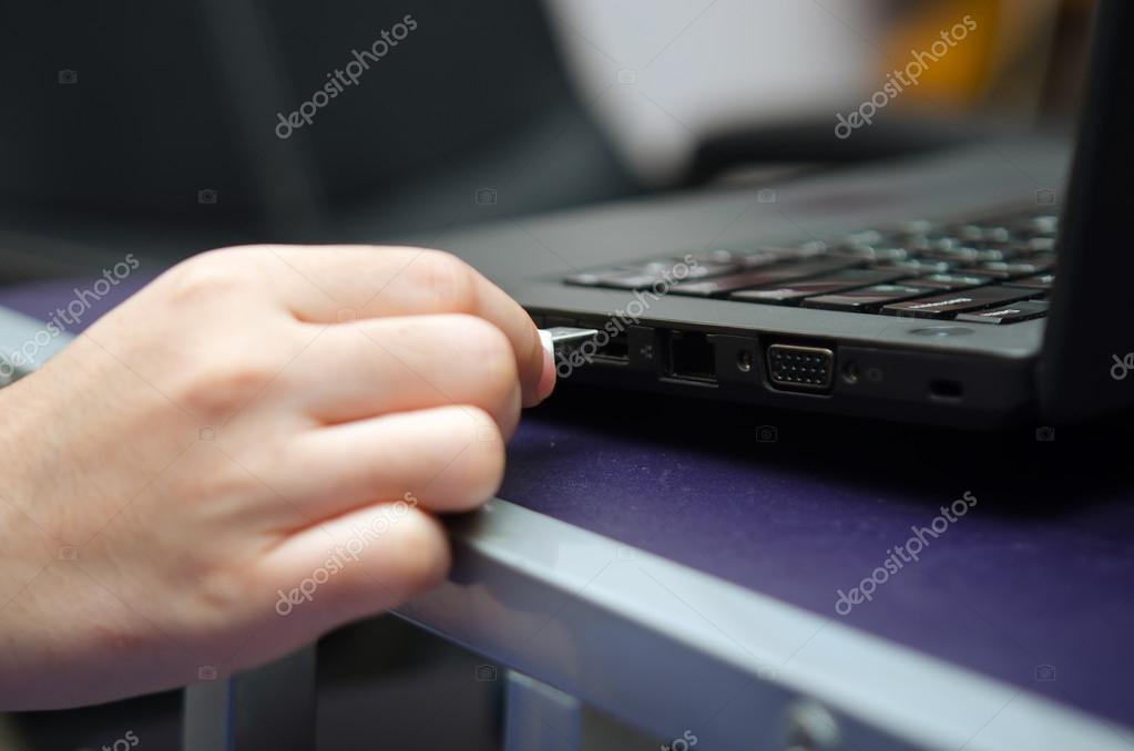 Virus USB thumb drive plug in to laptop computer port — Stock Photo