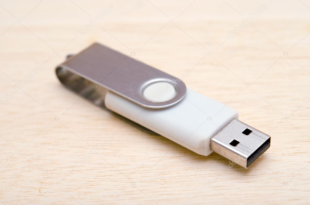 USB stick or USB thumb drive isolated on wooden board background