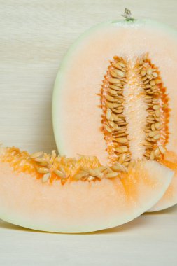 Kavun veya Charentais kavun yarısı ve tohumlar üzerinde ahşap boa