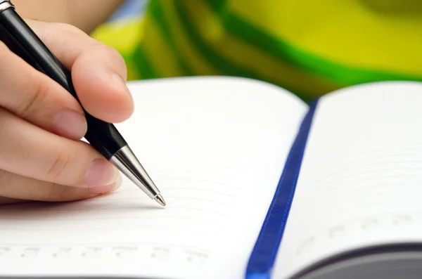 Aktivität mit Stift und Buch schreiben Stockbild