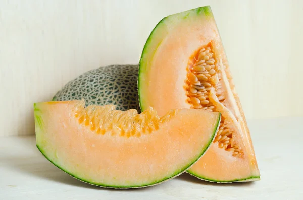 Cucumis melo oder Melone mit Hälfte und Samen auf Holzteller (andere — Stockfoto