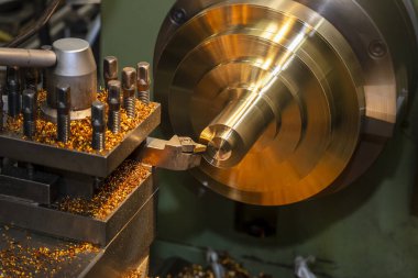 Torna makinesinin çalışması pirinç maddi parçalarını kesme araçlarıyla kesiyor. Makineyi döndürerek metal işleme süreci.