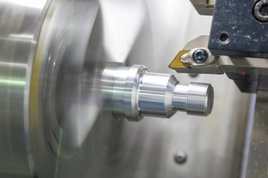 CNC torna makinesi metal şaft kısmını kesiyor. Makineyi döndürerek yüksek hassasiyetli parça üretim süreci.