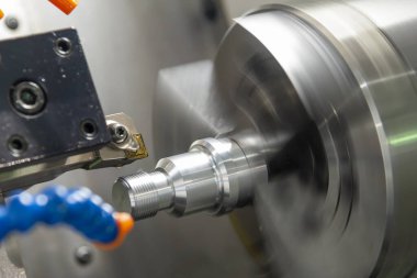 CNC torna makinesi metal şaft kısmını kesiyor. Makineyi döndürerek yüksek hassasiyetli parça üretim süreci.