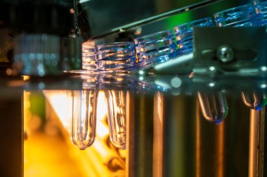 Üfleme makinesindeki PET şişesinin ön biçimi. PET şişe işleme işlemi üfleme kalıbı ile işlem.