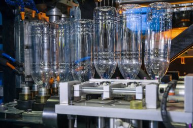 Üfleme makinesindeki PET şişesi. PET şişe işleme işlemi üfleme kalıbı ile işlem.