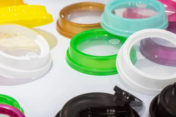 The pile of multi-colors plastic  drinking cup lid from injection processing. The plastic injection part manufacturing concept.