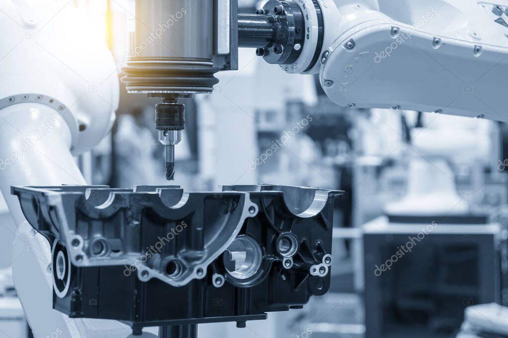 The automotive parts finishing process by milling process attached the robotics arm. The hi-technology automotive parts manufacturing process by robotics system.