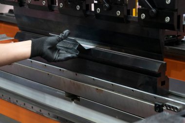 Hidrolik fren bükme makinesiyle çalışan teknisyen. Yetenek operatörünün kullandığı levha metal çalışması.