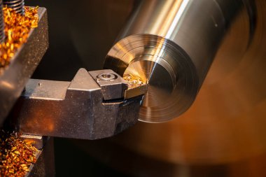 Torna makinesinin yakın çekim sahnesi pirinç şaft malzemesini işlemeyi bitirdi. Makineyi döndürerek metal işleme süreci.