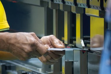 Bükme makinesi operatörünü kapatın metal levha parçalarını tutun. Yetenek operatörünün kullandığı levha metal çalışması.