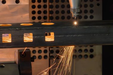 Sahneyi kapatın, fiber lazer kesme makinesi kare paslanmaz çelik tüpü kesti. Lazer kesme makinesinin yüksek teknoloji metal üretim süreci.. 