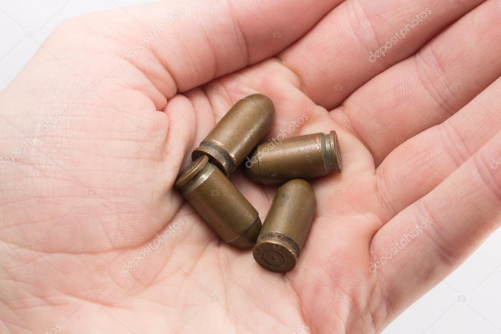 Pistol bullets in a hand — Stock Photo © m_a_n 85112194