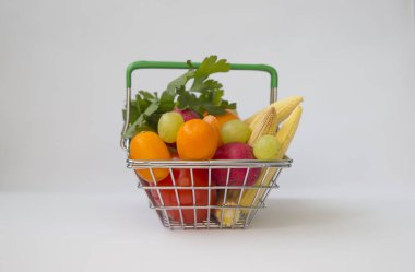 Mini meyve ve sebze dolu alışveriş sepeti.