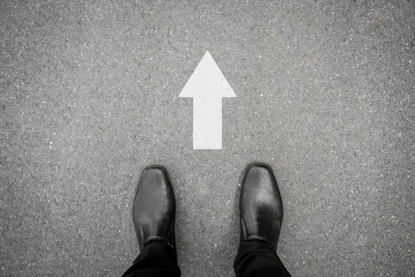 Black shoes and direction sign to go ahead — Stock Photo, Image