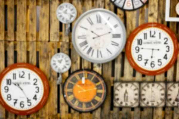 Abstract blur clocks on wooden wall — Stock Photo, Image