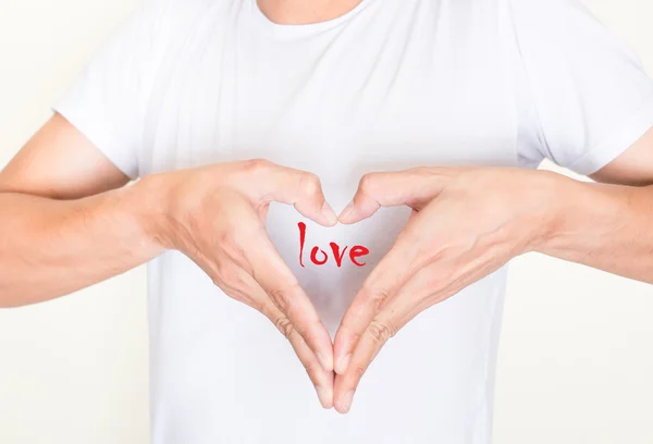 Herzförmige Hände auf der linken Brustseite mit Liebe im Inneren — Stockfoto