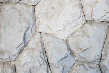 Arka plan olarak ayrıntılı olarak taş duvar