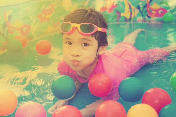 Baby girl playing in kiddie pool - vintage effect — Stock Photo, Image