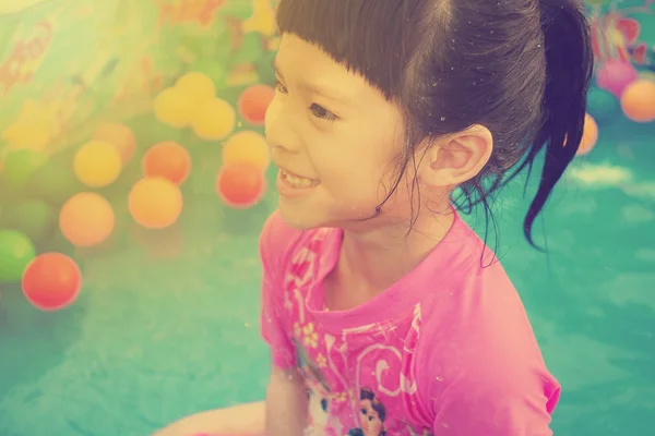 Baby girl playing in kiddie pool - vintage effect — Stock Photo, Image