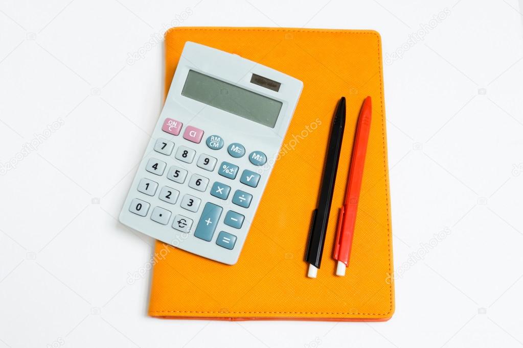 Isolated calculator, notebook and pen