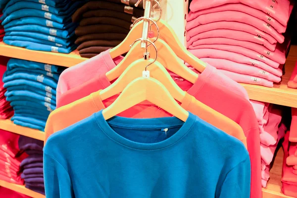 Colorful t-shirt on rack — Stock Photo, Image