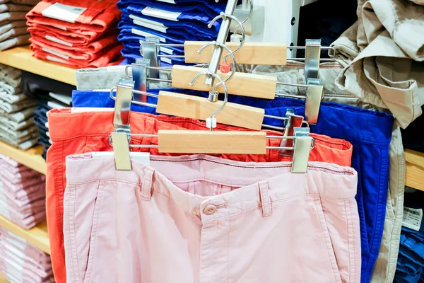Colorful trousers on rack — Stock Photo, Image