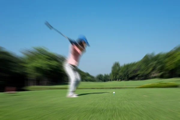 Motion blur golfer swinging driver club — Stock Photo, Image