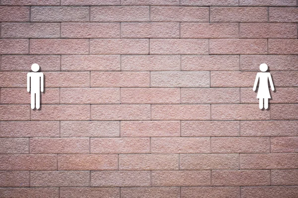 Man and woman symbols on brick wall