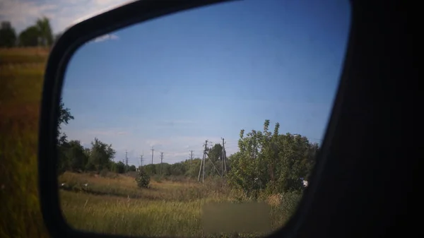 Nature through the car mirror.