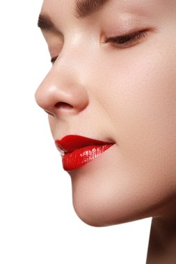 Close-up shot of woman lips with red lipstick. Beautiful perfect lips. Sexy mouth close up. Beautiful wide smile of young fresh woman with full lips. Isolated over white background