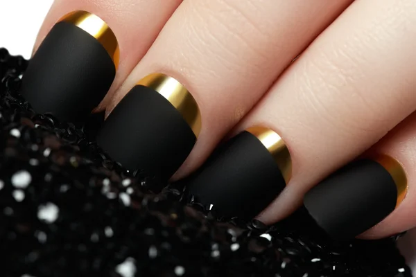Manicure. Black matte nail polish. Manicured nail with black matte nail polish. Manicure with dark nailpolish. Golden nail art manicure. Holiday style bright manicure — Stock Image Manicure. Black matte nail polish. Manicured nail with black matte nail polish. Manicure with dark nailpolish. Golden nail art manicure. Holiday style bright manicure Stock Image