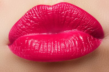 Close-up of a beautiful sexy red lips giving kiss. Nice full lips with pink lips makeup. Fashion make-up. Sexy lips. Beauty pink lips makeup detail.