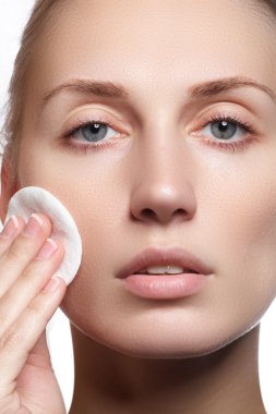 Temiz Cilt yakın çekim güzel genç kadın. Güzel kadın yüz studio beyaz üzerine kapatın. Genç kadın kozmetik krem temiz taze bir yüz. Cilt bakım kavramı