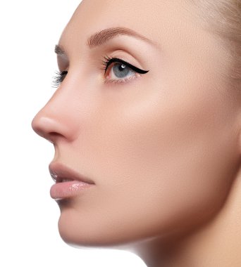 Beautiful face of young woman with clean fresh skin. Portrait of beautiful young woman with beautiful blue eyes and face - on white background. Close-up portrait of beautiful woman's purity face with natural make-up. Cute model with clean shiny skin