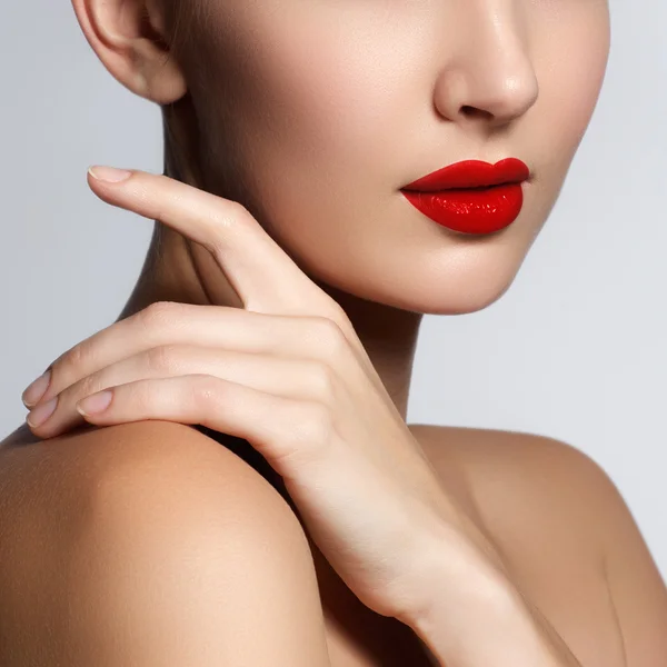 Beautiful young model with red lips and french manicure. Part of female face with red lips. Close-up shot of woman lips with glossy red lipstick. Glamour red lips make-up, purity skin. Retro beauty style — Stok fotoğraf